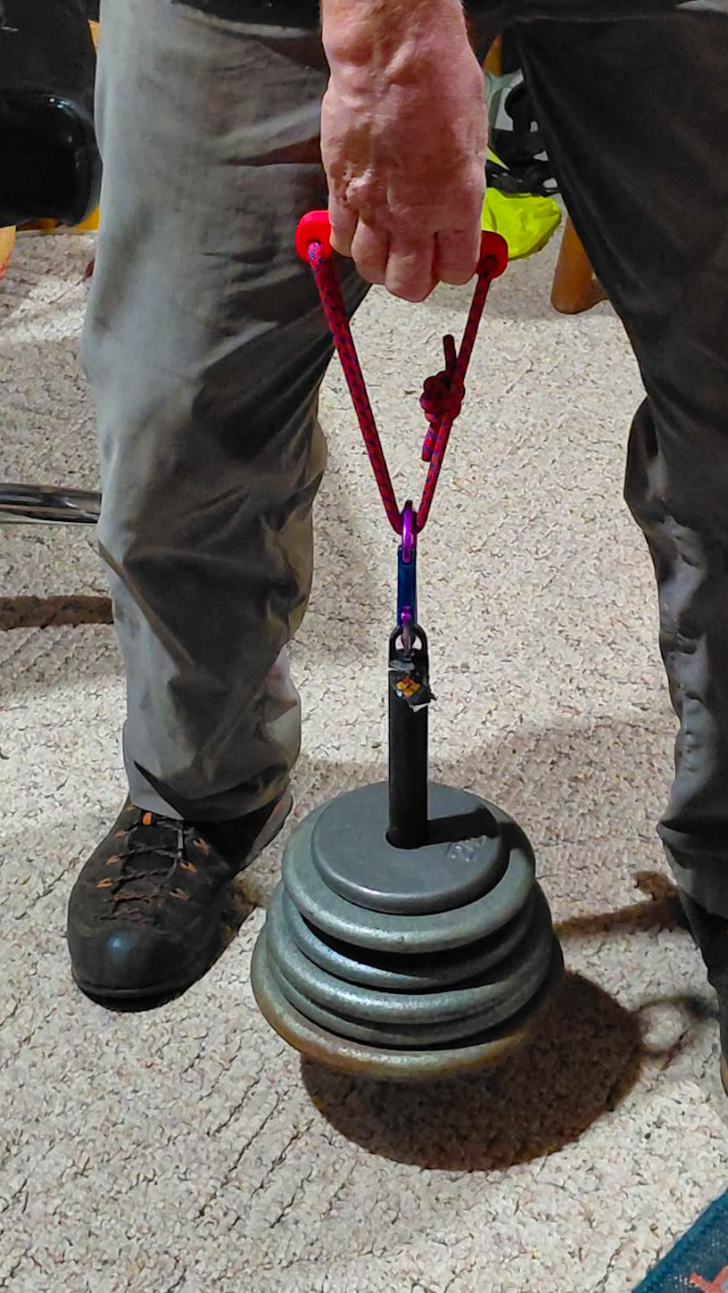 Person holding a minimalist attached to a loading pin. 